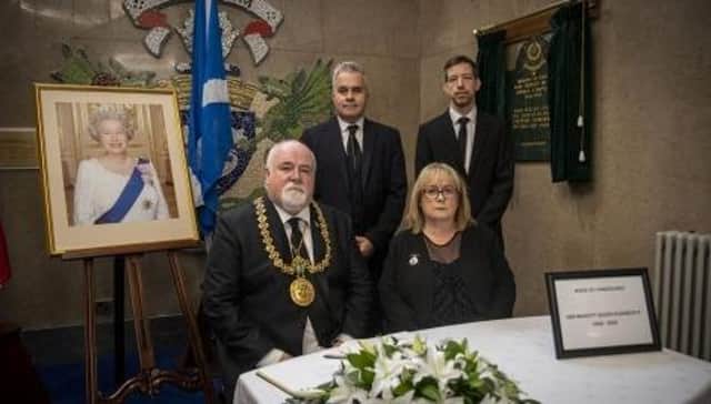 Lord Provost Bill Campbell, Lady Provost Yvonne Campbell, council leader John Alexander and chief executive Greg Colgan with the Book of Condolence.