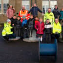 Pauline Allison and contractors are pictured with Murroes pupils.