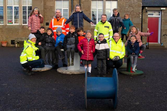Pauline Allison and contractors are pictured with Murroes pupils.