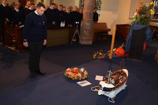Volunteer coxswain Michale Marr lays a wreath on behalf of Broughty Ferry’s lifeboat crew. The church service was conducted by Rev Nick Baker and Rev Chris Hay. (Wallace Ferrier)
