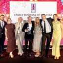 ​Members of the team are pictured celebrating after receiving their award.