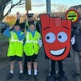​Some of the pupils are pictured outside the school with Living Streets mascot Strider.