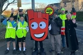 ​Some of the pupils are pictured outside the school with Living Streets mascot Strider.