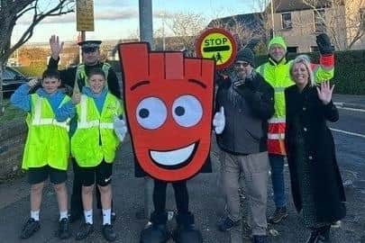 Some of the pupils are pictured outside the school with Living Streets mascot Strider.