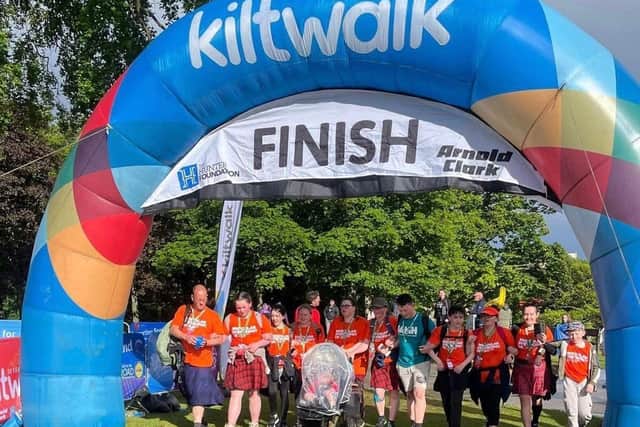 Veronica and family crossing the finish line at the Aberdeen Kiltwalk