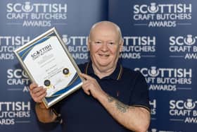 ​Butcher Jon Milne with the award for the business’s black pudding. (Pic: Graeme Hart)