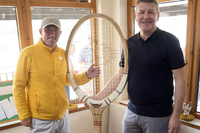 David Baxter (right) presented club coach Graeme Walker with this giant wooden racket from his late father C V Baxter’s collection