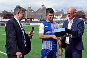 Montrose chairman John Crawford presents a gift to the long serving midfielder