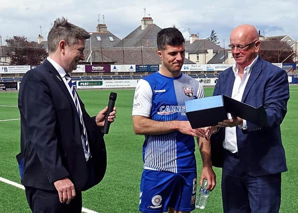 Montrose chairman John Crawford presents a gift to the long serving midfielder