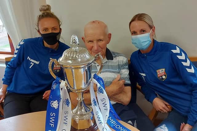 Lisa Anderson, resident Ron Watson and Eilidh Reid with the league trophy
