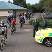 Medics Jim and Colin Petrie are pictured alongside the cyclists. (Wallace Ferrier)