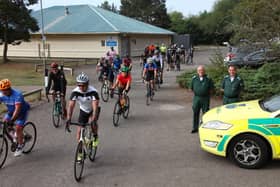 Medics Jim and Colin Petrie are pictured alongside the cyclists. (Wallace Ferrier)