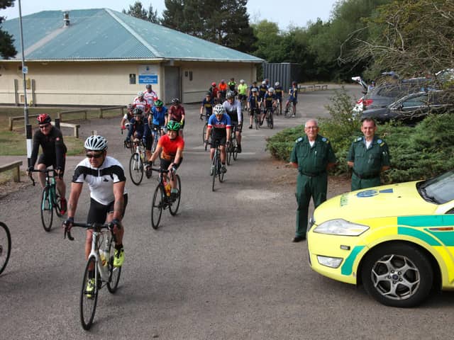 Medics Jim and Colin Petrie are pictured alongside the cyclists. (Wallace Ferrier)