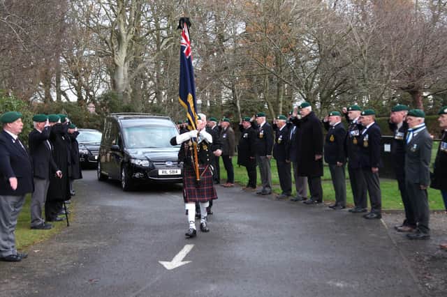 The Royal Marine Falkland veterans line up and salute as the hearse passes by.