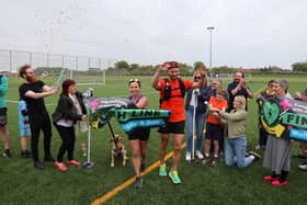 Vicky and Dale are pictured crossing the finishing line after completing their 35-mile run. (Wallace Ferrier