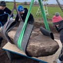 Team members carefully remove the rare stone from its resting place in a field near Aberlemno. It is now undergoing further analysis.