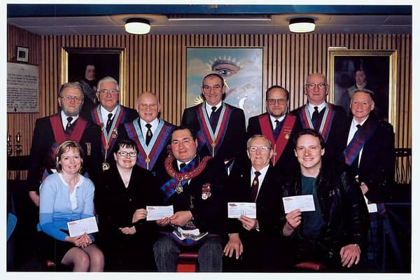 The Provincial Grand Royal Arch Chapter of Angus and Mearns presented four cheques, each for £1,500, at a meeting in their rooms at Princes Street, Dundee in March, 2002. Pictured after the presentation were, from left, back - Commissioned office bearers John Campbell, Jim Smith, Frank Sandilands, Bill Greig, Bill Beckers, Willie Mackenzie and Willie Campbell: front - Alison Wright, Special Care Baby Unit, Ninewells Hospital; Trudi Fraser, Tayside Children with Cancer and Leukaemia; Grand Superintendent Bill McEwan, Ian Coull, ENABLE; and Grant Reid, Caring for Kids.