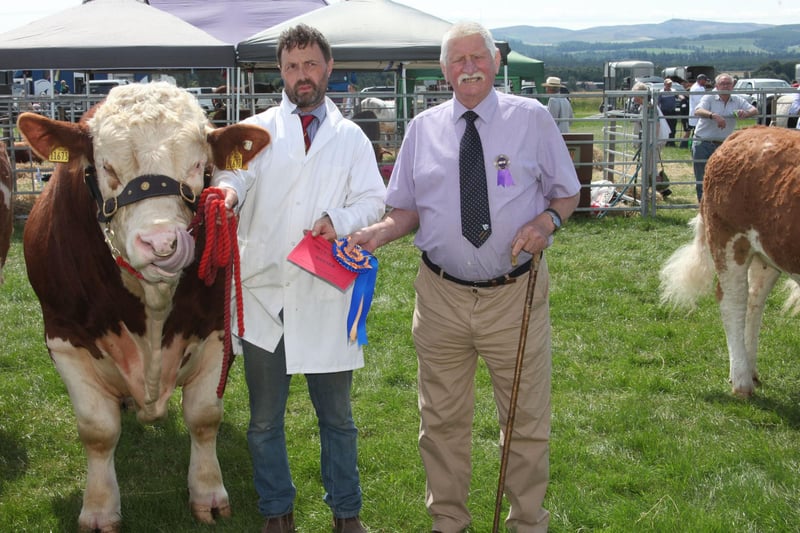Kenny McKeague with the Champion Simmental group of three, from Crudie Simmentals Tannadice. Also pictured is judge Jim Muirhead.