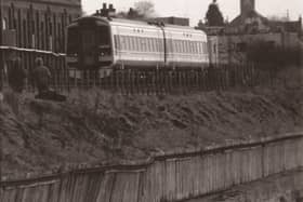 Fears for the railway line at Monifieth in March, 1996 were caused by the bulge on the fence at the path - not shared by those watching the train.