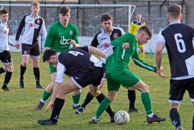Roselea's Sam Garnham on the ball as Fergus Alberts watches on. Pic by Mal Turnbull