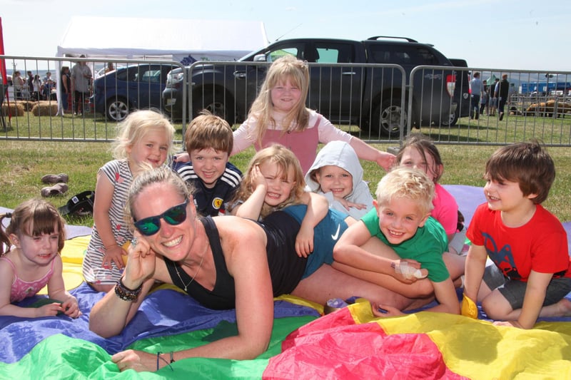 Children`s yoga instructor Linda Mackie of Creative Spank Yoga swamped by some of her pupils.