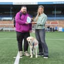 Jon Attenborough and his Labrador Sam with the SPFL's Molly Hyde at Station Park, Forfar. Picture: SPFL/Christopher Coutts/SWNS
