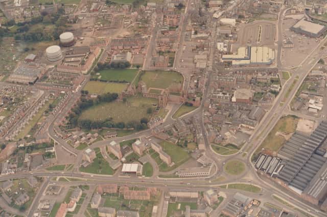 This undated aerial view of Arbroath was taken after the Abbeygate and Safeway had been built, but before industrial buildings had been demolished for Morrison's. The gas holders at the top left had not been knocked down, and the public road through the Abbey still existed. And the roundabout leading Burnside Drive into the road to Montrose was still a sensible size.