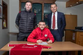 Nathan Cooney signs on at City watched on by Andy Kirk and chairman Kevin Mackie. Pic by Graeme Youngson