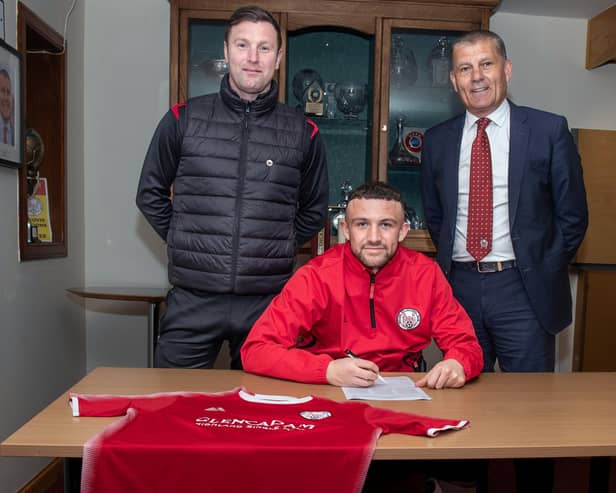 Nathan Cooney signs on at City watched on by Andy Kirk and chairman Kevin Mackie. Pic by Graeme Youngson