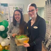 Heather Bowman celebrating £15 off her specs. Staff member Eva Warburton.