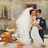 Groom holds bride's waist tenderly at a wedding in Spain