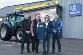 Gordon Cairns, (second left) welcomes Agricar Group to the sponsorship team with a top for Finance Director Wendy Smith, watched by Directors Mike Milne and Derek Johnston.