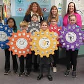 Head teacher Jennifer Garnes is pictured with staff and pupils and some of the Emotional Works materials used in classes.