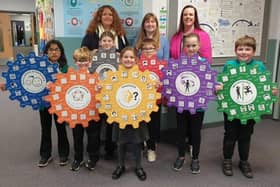 Head teacher Jennifer Garnes is pictured with staff and pupils and some of the Emotional Works materials used in classes.